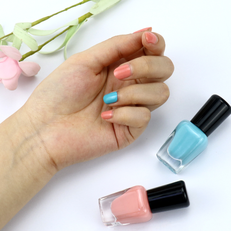 Private label water-based nail polish apply on finger